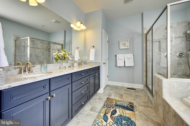 bathroom with tile flooring, a shower with door, and dual bowl vanity