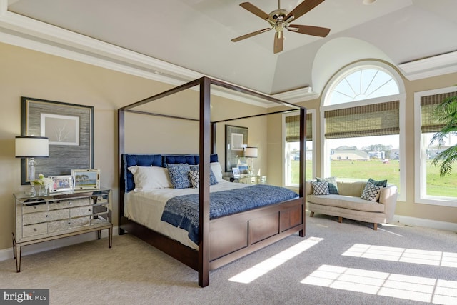 carpeted bedroom with a tray ceiling, ceiling fan, and ornamental molding