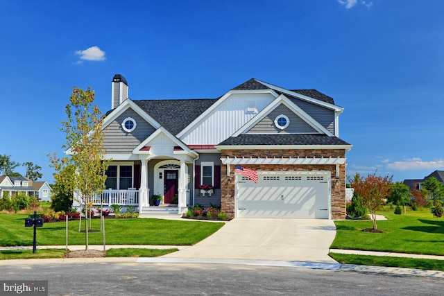 craftsman inspired home featuring a front yard, a porch, and a garage