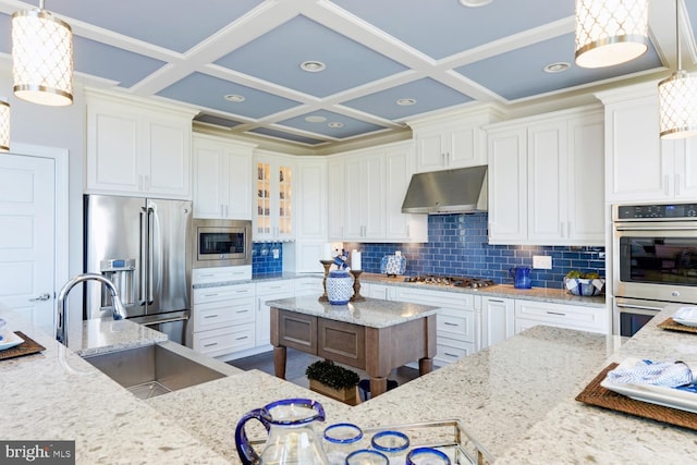 kitchen with decorative light fixtures, white cabinets, and appliances with stainless steel finishes