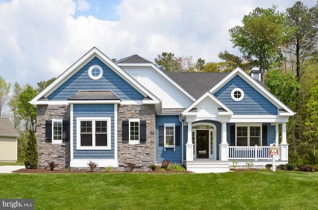 craftsman-style home with covered porch and a front lawn