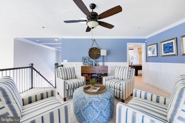 living room featuring ceiling fan, crown molding, and light colored carpet