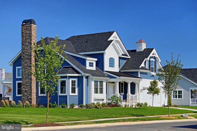 view of front of property with covered porch and a front yard