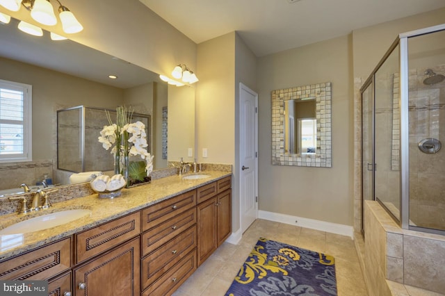 bathroom featuring walk in shower, double sink, large vanity, and tile flooring