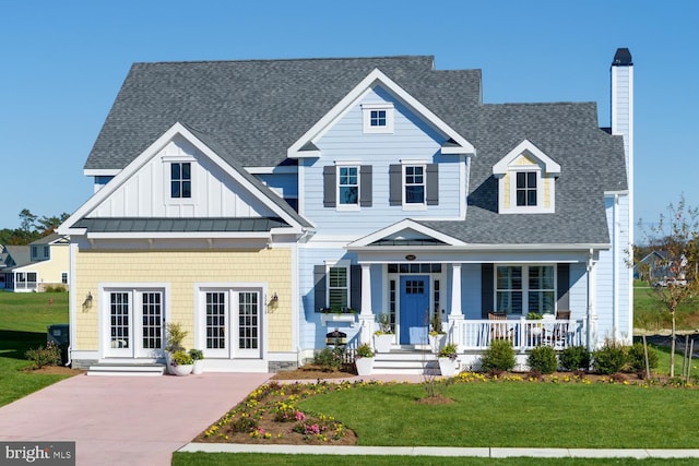 view of front facade with covered porch and a front lawn