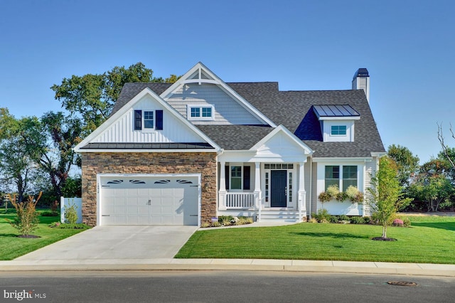 craftsman house featuring a front yard, a porch, and a garage