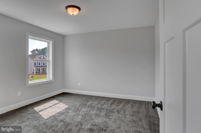 carpeted spare room featuring a wealth of natural light