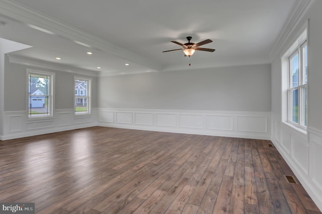 spare room featuring ornamental molding, ceiling fan, dark hardwood / wood-style floors, and a wealth of natural light