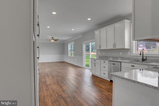 kitchen with white cabinets, stainless steel dishwasher, dark wood-type flooring, and a healthy amount of sunlight