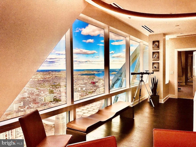 interior space featuring a water view and dark wood-type flooring