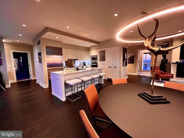 dining room with sink and dark wood-type flooring