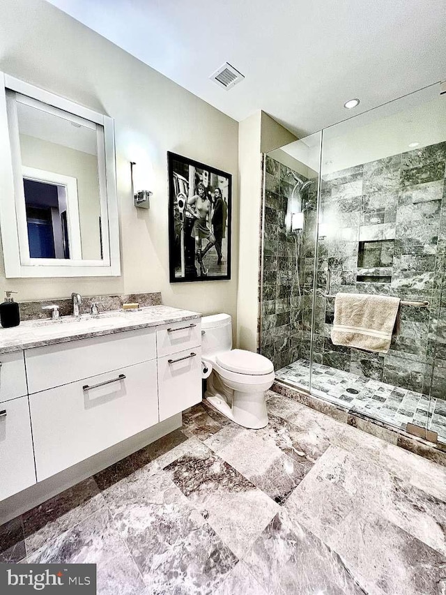 bathroom featuring walk in shower, toilet, tile floors, and vanity