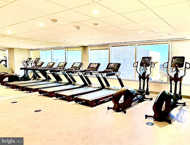 gym with a paneled ceiling