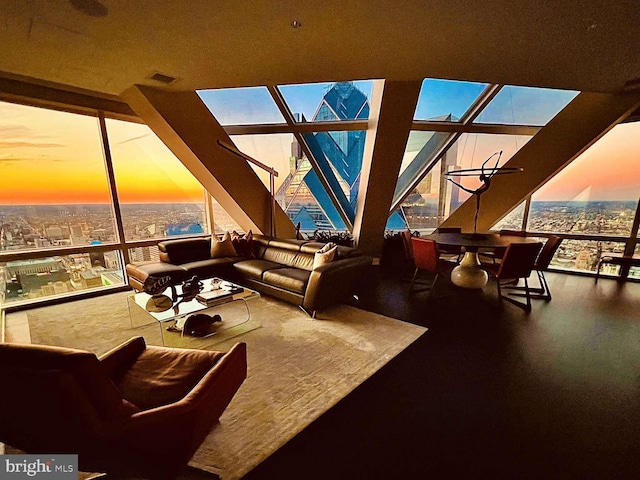 living room with floor to ceiling windows and a healthy amount of sunlight