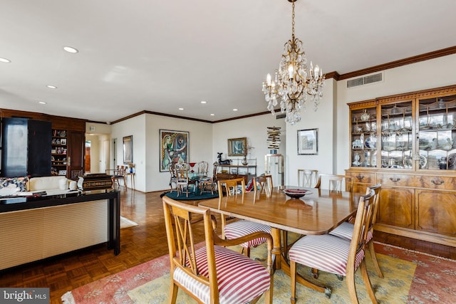 dining area with dark parquet floors, an inviting chandelier, and ornamental molding