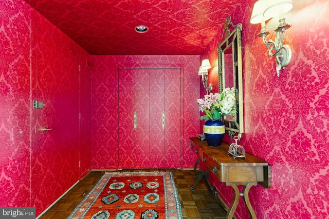 corridor featuring dark parquet flooring