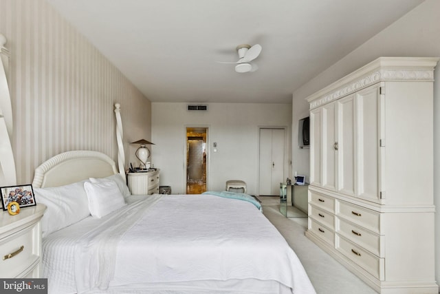 bedroom featuring ceiling fan and light carpet