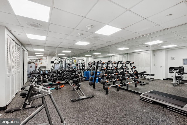 workout area featuring a drop ceiling