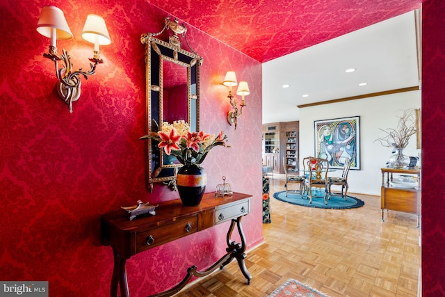 hall with crown molding and light parquet floors