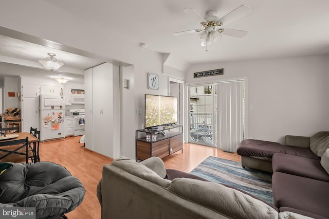 living room featuring lofted ceiling, light hardwood / wood-style flooring, and ceiling fan