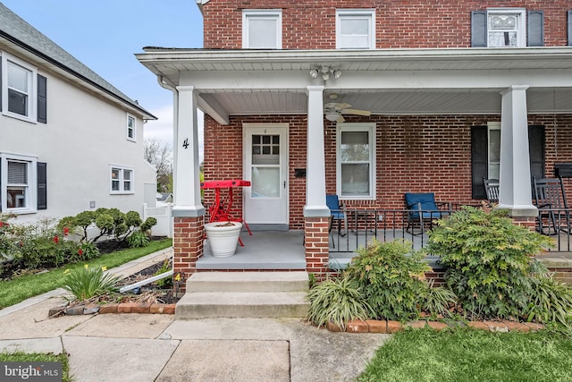 view of exterior entry with covered porch and ceiling fan