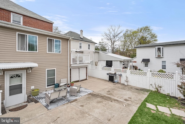 rear view of property with a patio area and an outdoor living space