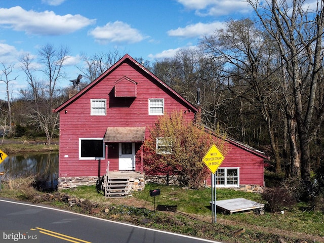 view of front of house with a water view