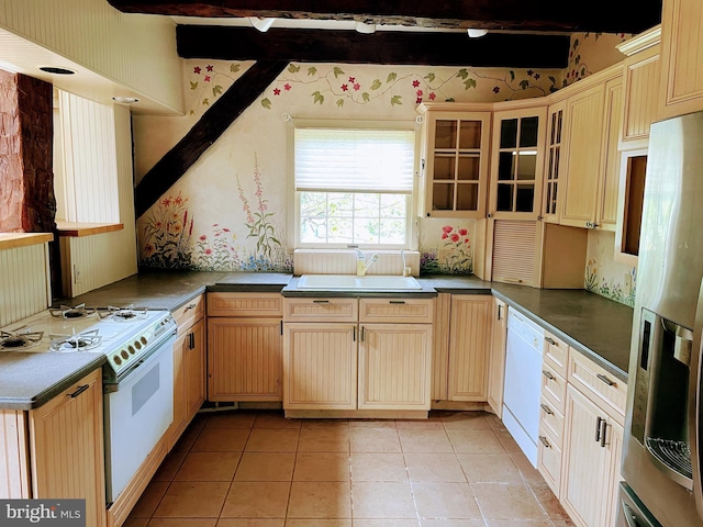 kitchen with light tile patterned floors, white appliances, light brown cabinets, and sink