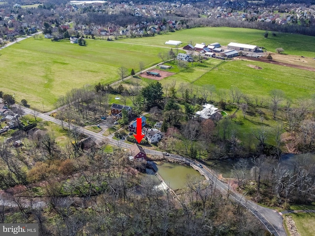 drone / aerial view with a water view and a rural view