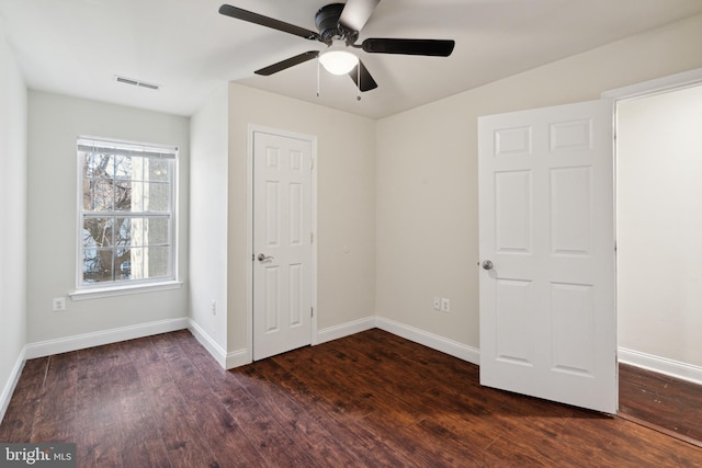 unfurnished room featuring ceiling fan and dark hardwood / wood-style flooring