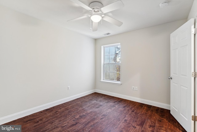 spare room featuring dark hardwood / wood-style flooring and ceiling fan