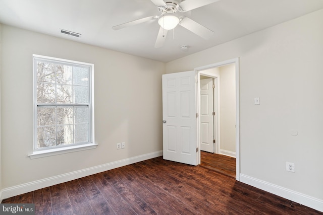 empty room featuring ceiling fan and dark wood-type flooring