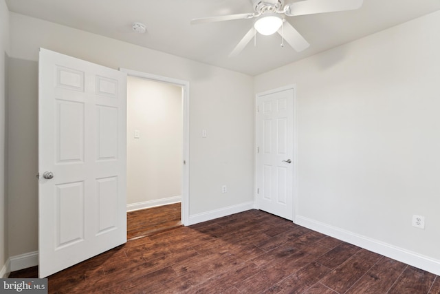 unfurnished bedroom with dark hardwood / wood-style flooring and ceiling fan