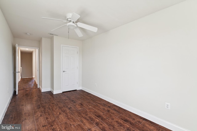 unfurnished bedroom featuring ceiling fan and dark wood-type flooring