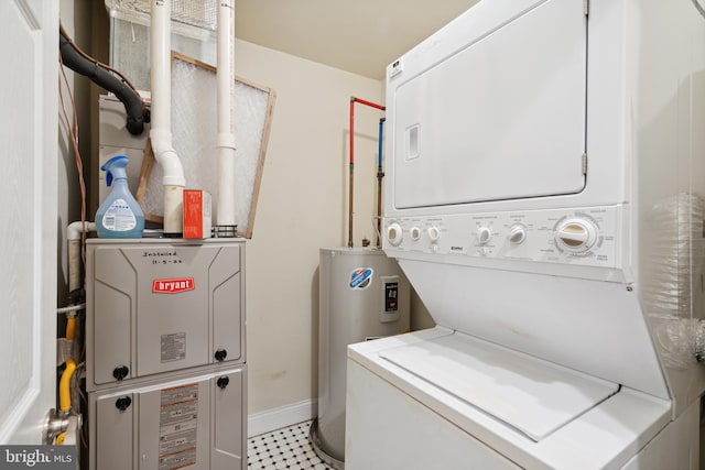 laundry area with light tile floors, electric water heater, and stacked washer and clothes dryer