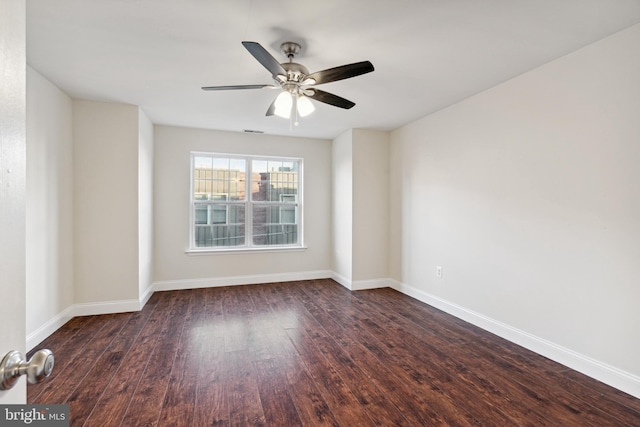 empty room with ceiling fan and dark hardwood / wood-style floors