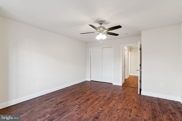 unfurnished bedroom with ceiling fan, a closet, and dark hardwood / wood-style floors