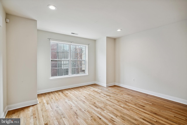 empty room with light hardwood / wood-style flooring