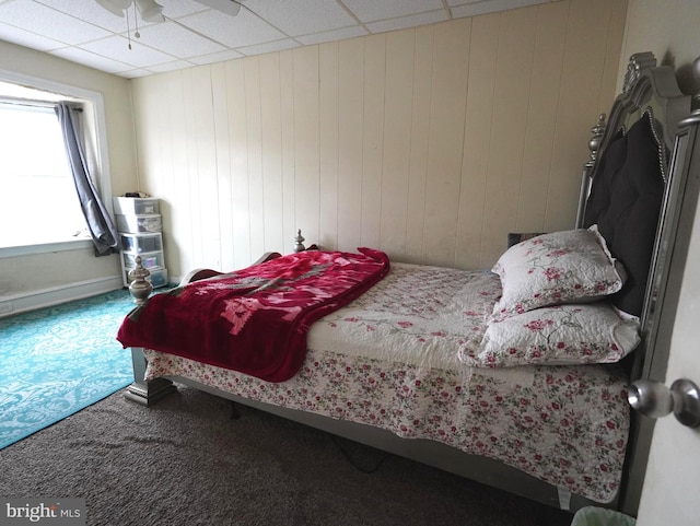 bedroom featuring a paneled ceiling, ceiling fan, and carpet floors