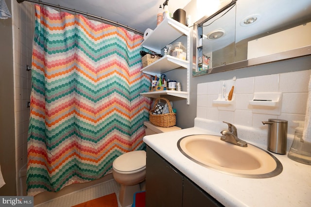 bathroom featuring tile walls, backsplash, toilet, and large vanity