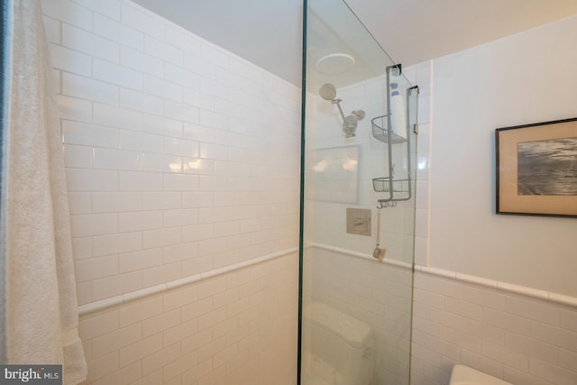 bathroom with tile walls and walk in shower