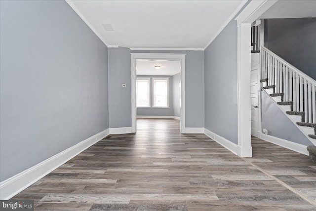 empty room featuring dark hardwood / wood-style floors and ornamental molding