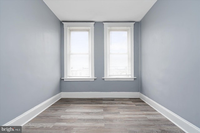 spare room with light hardwood / wood-style flooring