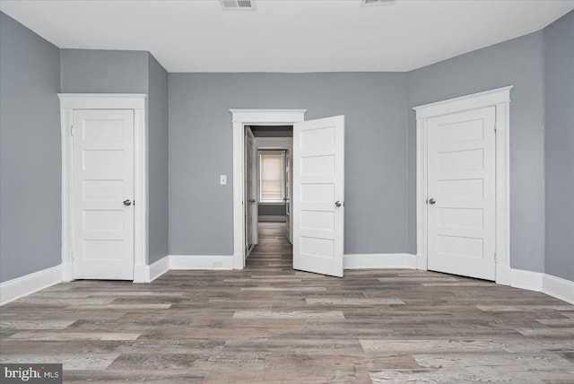 unfurnished bedroom featuring hardwood / wood-style flooring