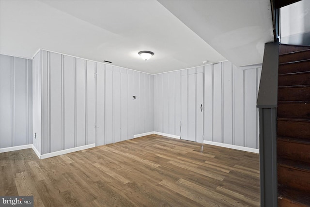 basement with dark hardwood / wood-style floors