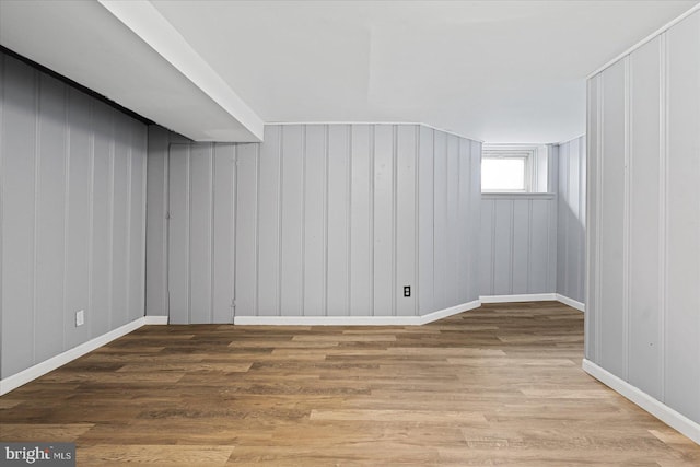 basement with hardwood / wood-style floors