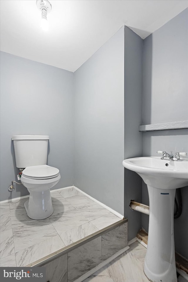 bathroom with sink, tile flooring, and toilet