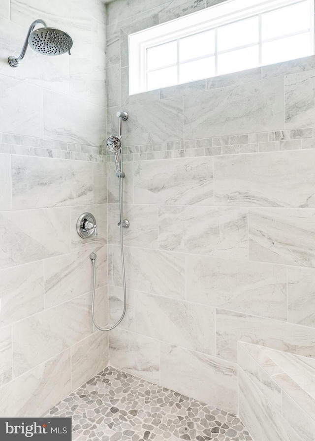 bathroom with a tile shower