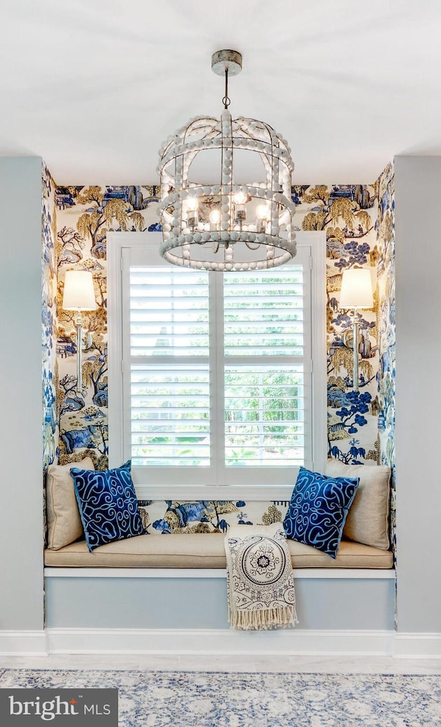 living area with a healthy amount of sunlight and a notable chandelier