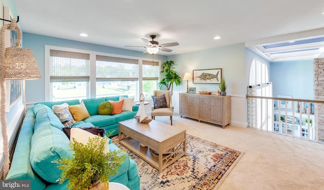 carpeted living room featuring ceiling fan